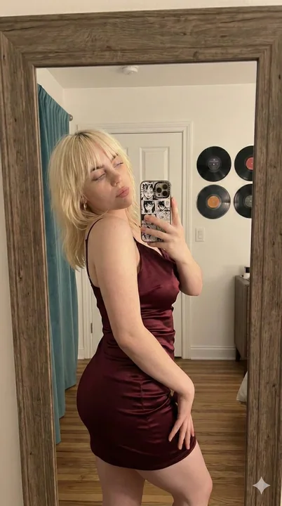 Selfie of a girl in a slightly drunken wine-red satin dress in her bedroom