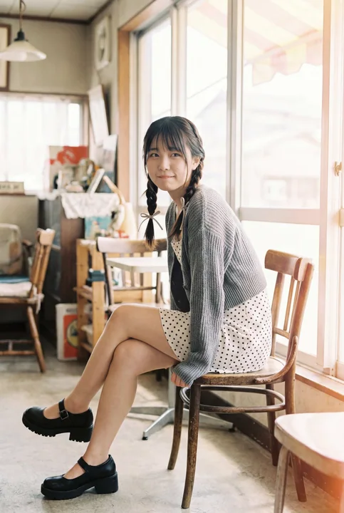 A woman in a sunlit retro café