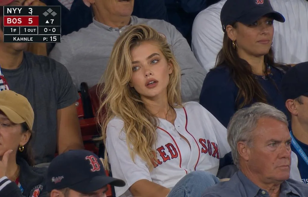 Candid realistic shot of spectators in the baseball live broadcast stands