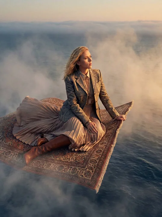 A dreamy high-fashion editorial of a magic carpet flying over a misty sea.
