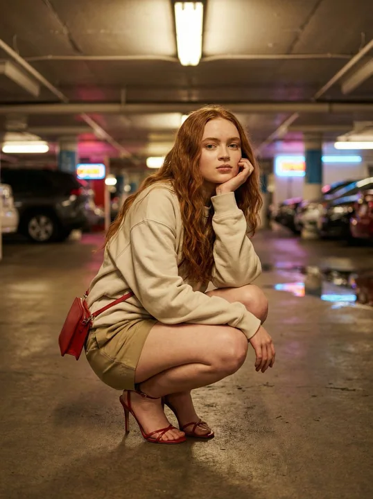 A pink fashion editorial under the neon lights and shadows of an underground parking garage